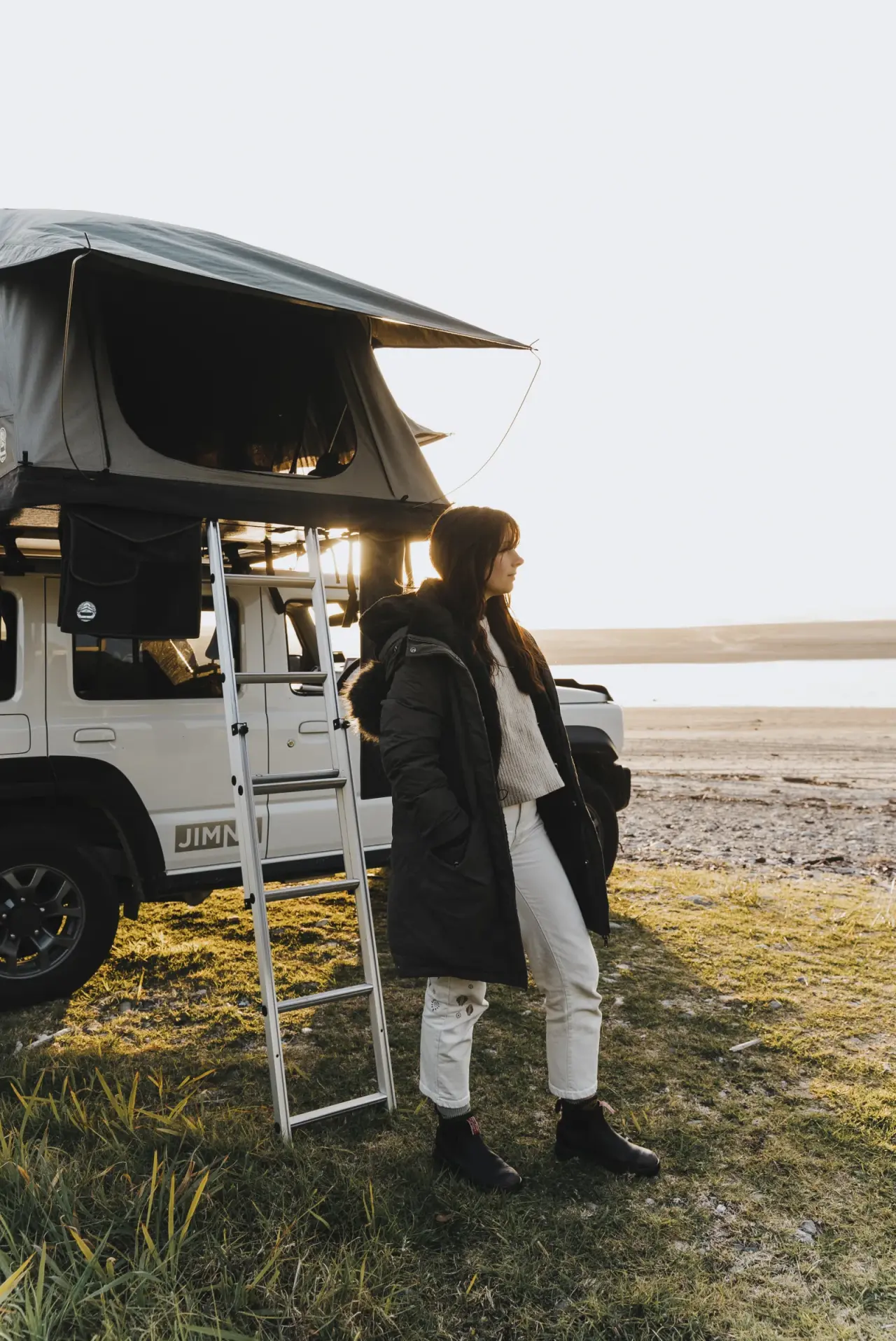 Suzuki Jimny in outdoor adventure setting with scenic backdrop. – Jimny Rentals.